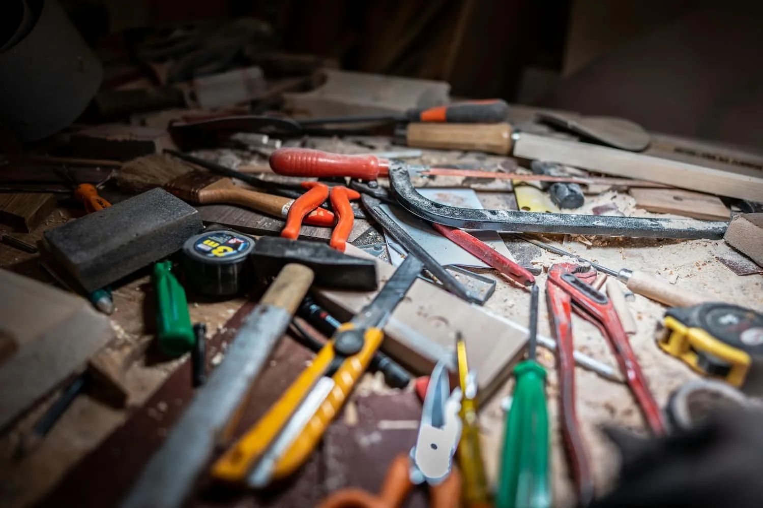 Unorganized tools scattered across a workbench